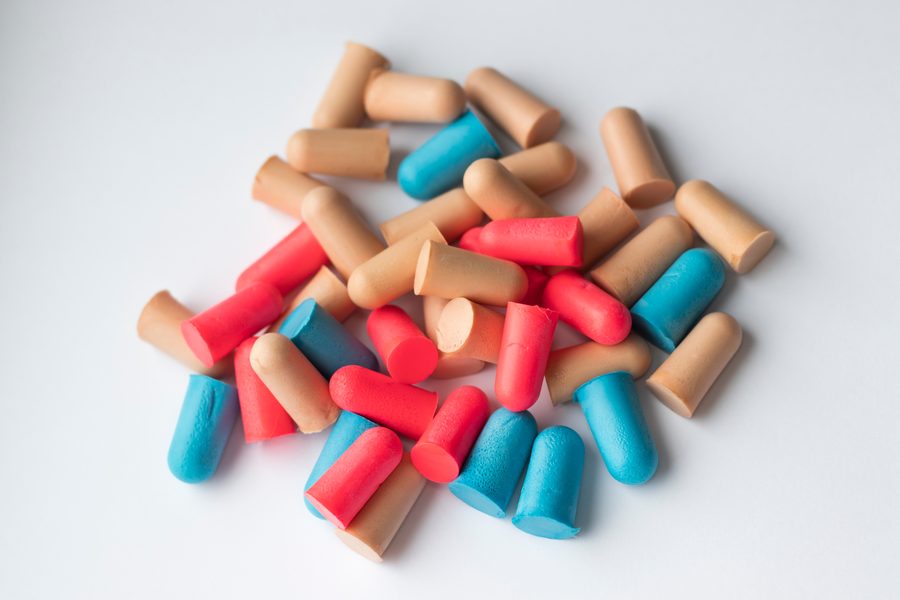 Colorful foam earplugs on a white background