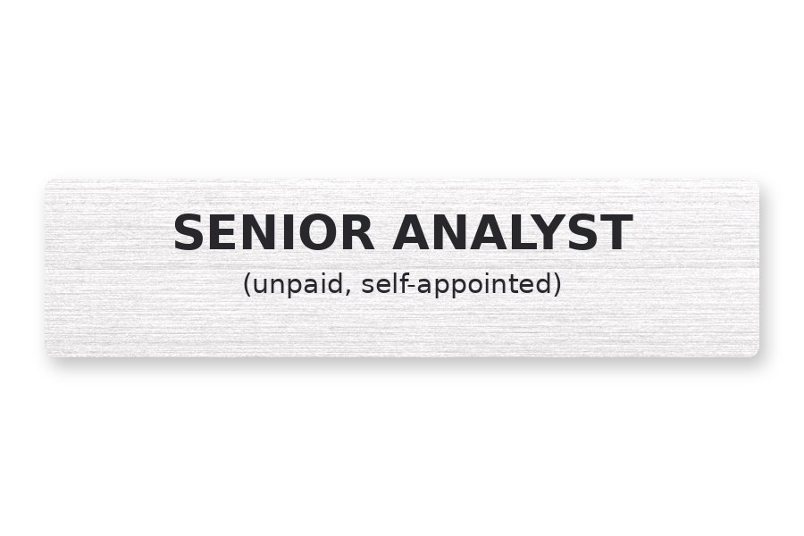 A brushed aluminium name plate engraved with 'SENIOR ANALYST (unpaid, self-appointed)'