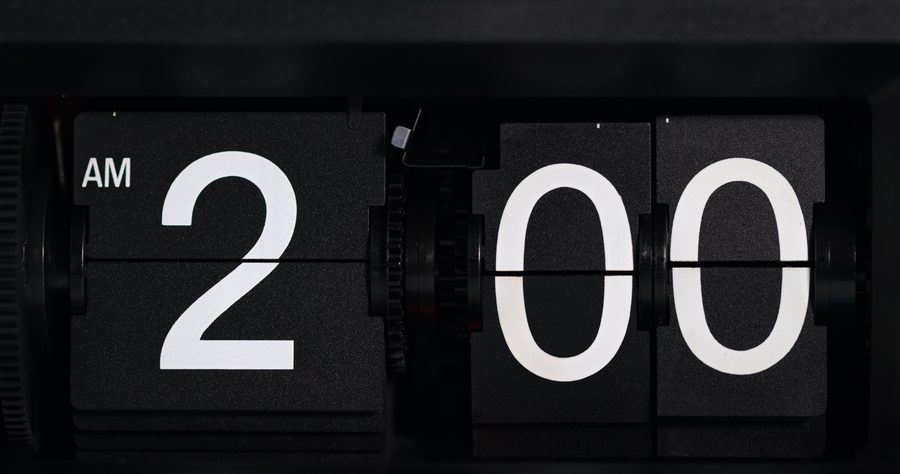 A black retro flip clock showing 2:00 AM