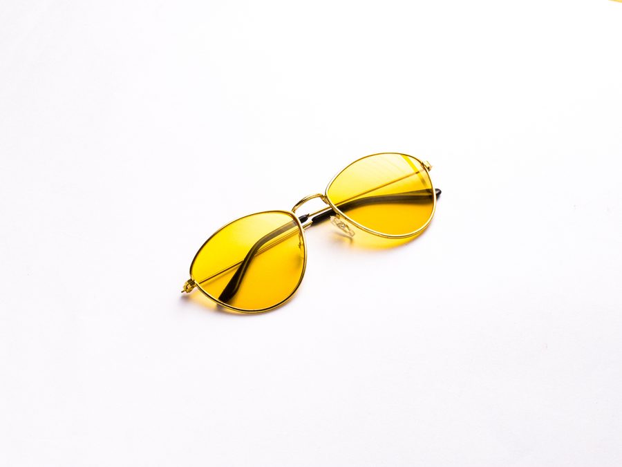 Slim rectangular sunglasses with a thin gold frame and yellow lenses