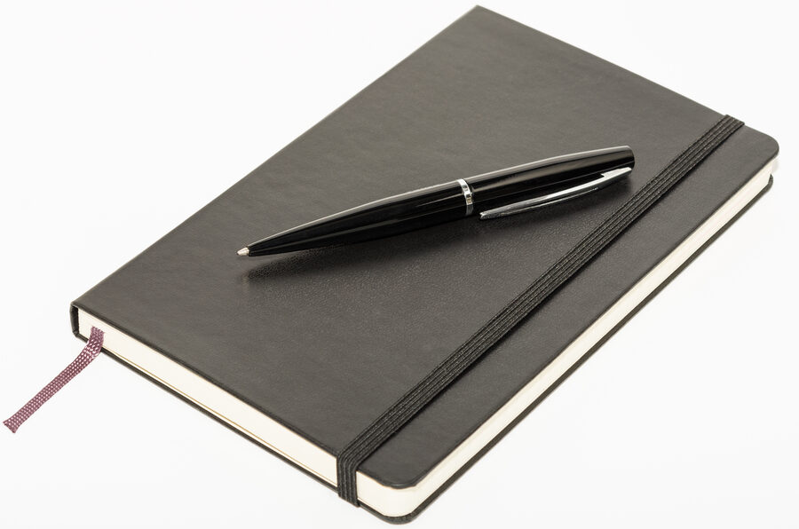 A black leather notebook with a pen