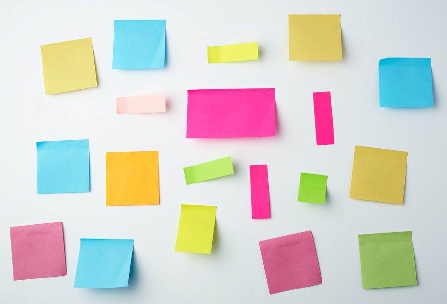 Colorful sticky notes scattered on a white surface